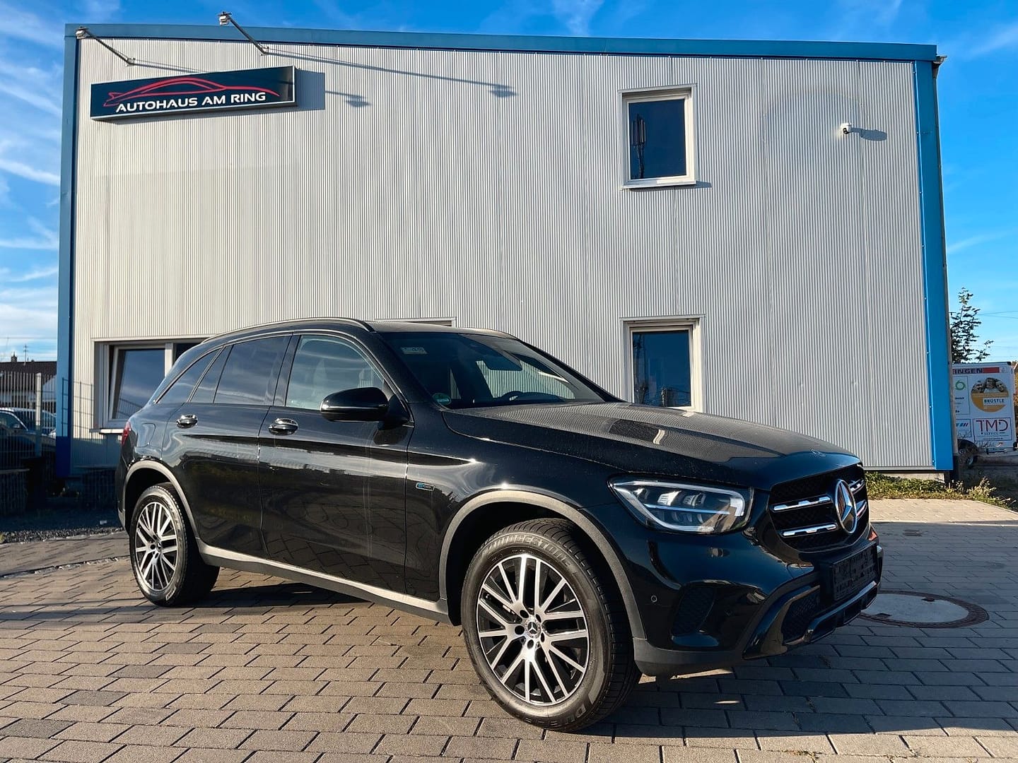 Mercedes-Benz GLC 300 e 4MATIC in Schwarz, schräg von vorn, vor der Halle in Illingen